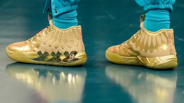 Charlotte Hornets guard LaMelo Ball's gold PUMA sneakers.